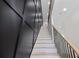 Modern staircase with black accent wall and wood handrail at 178 Wesley Ne Ave # B, Atlanta, GA 30307