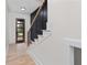 Light-filled foyer showcases a modern staircase with light wood treads and black metal railing at 178 Wesley Ne Ave # B, Atlanta, GA 30307