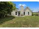 Back of home featuring a chimney, a small patio, and a well-kept lawn at 3357 Saddleton Way, Douglasville, GA 30134