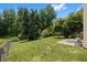 Spacious backyard with a concrete patio area and chain link fence at 3357 Saddleton Way, Douglasville, GA 30134