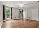 Bright bedroom featuring wood-look floors, two windows, and a double closet at 3357 Saddleton Way, Douglasville, GA 30134