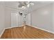 Neutral bedroom featuring wood-look floors, a ceiling fan, and an open closet at 3357 Saddleton Way, Douglasville, GA 30134