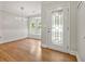 Charming entryway with a decorative glass door, view to the breakfast nook, and hardwood floors at 3357 Saddleton Way, Douglasville, GA 30134