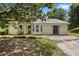 Charming home featuring a stone accent, light yellow siding, and a unique turret-style window at 3357 Saddleton Way, Douglasville, GA 30134