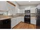 Bright kitchen featuring stainless steel appliances, white cabinets, and a stylish backsplash, enhancing the cooking space at 3357 Saddleton Way, Douglasville, GA 30134