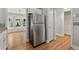 Kitchen showcasing stainless refrigerator, view to the adjacent breakfast nook, and access to a side entry at 3357 Saddleton Way, Douglasville, GA 30134