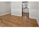Open-concept living room with seamless hardwood floors, with view to the kitchen at 3357 Saddleton Way, Douglasville, GA 30134