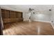 Spacious living room with wood-look floors and a built-in bookshelf with cabinets at 3357 Saddleton Way, Douglasville, GA 30134