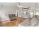 Bright living room with view to kitchen, hardwood floors, and neutral décor, creating a comfortable, welcoming space at 3357 Saddleton Way, Douglasville, GA 30134