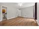 Spacious main bedroom featuring wood-look floors, a ceiling fan, and an attached bathroom at 3357 Saddleton Way, Douglasville, GA 30134