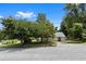Charming single-story home with a metal roof nestled among mature trees at 3357 Saddleton Way, Douglasville, GA 30134