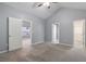 Spacious bedroom with neutral carpet, vaulted ceiling, and three open doorways at 412 Mcafee Nw Ct # 14, Kennesaw, GA 30144