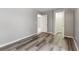 Bedroom featuring wood-look flooring, gray walls, white trim, and a closet at 412 Mcafee Nw Ct # 14, Kennesaw, GA 30144