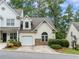 Charming townhome with a one-car garage, stone accents and mature landscaping provides great curb appeal at 412 Mcafee Nw Ct # 14, Kennesaw, GA 30144