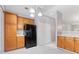 Functional kitchen featuring stainless steel appliances, warm wood cabinetry, and easy access to the living area at 412 Mcafee Nw Ct # 14, Kennesaw, GA 30144