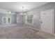 Inviting living room with soft carpeting, French doors to the backyard, and a welcoming front entrance at 412 Mcafee Nw Ct # 14, Kennesaw, GA 30144