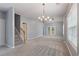 Spacious living room with neutral color palette, cozy carpeting, and natural light from the French doors at 412 Mcafee Nw Ct # 14, Kennesaw, GA 30144