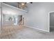 Open-concept living area with high ceilings, plush carpeting, and staircase leading to a second-story landing at 412 Mcafee Nw Ct # 14, Kennesaw, GA 30144