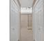 Bathroom entryway featuring tiled floor, glass shower and white doors at 4990 Sawgrass Nw Pl, Acworth, GA 30102