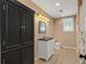 Bathroom features a vanity cabinet with black countertop and tile flooring at 4990 Sawgrass Nw Pl, Acworth, GA 30102