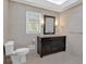Bathroom with tiled walls and floors, single dark vanity and window to let the light in at 4990 Sawgrass Nw Pl, Acworth, GA 30102