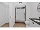 Modern bathroom features a glass shower, a sleek vanity with black countertop, and wood-look floors at 4990 Sawgrass Nw Pl, Acworth, GA 30102