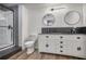 Modern bathroom with double sinks, stylish mirrors, and a sleek shower stall offers a spa-like experience at 4990 Sawgrass Nw Pl, Acworth, GA 30102