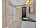 Cozy bathroom features a black vanity, patterned shower curtain, tile floors, and a framed mirror at 4990 Sawgrass Nw Pl, Acworth, GA 30102