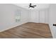 Bedroom features laminate floors, a window, and double-door closets at 4990 Sawgrass Nw Pl, Acworth, GA 30102