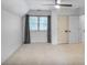 Bright bedroom featuring a ceiling fan, a window and neutral carpet at 4990 Sawgrass Nw Pl, Acworth, GA 30102