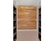 Walk-in closet featuring custom cedar planking and shelving at 4990 Sawgrass Nw Pl, Acworth, GA 30102