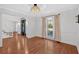 Elegant dining room with hardwood floors, a crystal chandelier, and large windows at 4990 Sawgrass Nw Pl, Acworth, GA 30102