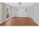 Bright dining room with hardwood floors, a crystal chandelier, and large windows at 4990 Sawgrass Nw Pl, Acworth, GA 30102