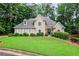 Charming home exterior with a well-maintained lawn and lush greenery at 4990 Sawgrass Nw Pl, Acworth, GA 30102