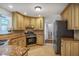 Well-lit kitchen featuring granite countertops, modern appliances, and tile flooring at 4990 Sawgrass Nw Pl, Acworth, GA 30102