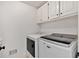 Bright laundry room with updated washer and dryer and ample storage at 4990 Sawgrass Nw Pl, Acworth, GA 30102