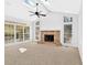 Bright living room with a ceiling fan, stone fireplace and lots of windows with natural light at 4990 Sawgrass Nw Pl, Acworth, GA 30102