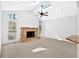 Light filled living room with fireplace, ceiling fan, and abundant natural light at 4990 Sawgrass Nw Pl, Acworth, GA 30102
