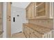 Walk-in pantry with granite countertops and upper and lower cabinets for storage at 4990 Sawgrass Nw Pl, Acworth, GA 30102