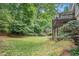 Spacious backyard featuring a large deck, mature trees, and lush green grass perfect for outdoor enjoyment at 1703 W Nancy Creek Ne Dr, Brookhaven, GA 30319