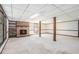 Unfinished basement featuring a brick fireplace, exposed ceiling, and natural light from nearby window at 1703 W Nancy Creek Ne Dr, Brookhaven, GA 30319