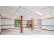 Unfinished basement with drop ceiling, windows, fireplace and wood support beams at 1703 W Nancy Creek Ne Dr, Brookhaven, GA 30319