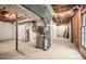 Unfinished basement featuring exposed pipes and equipment along with a nearby window and unfinished walls at 1703 W Nancy Creek Ne Dr, Brookhaven, GA 30319