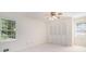 Bedroom with neutral walls, ceiling fan, carpet, closet doors and two windows at 1703 W Nancy Creek Ne Dr, Brookhaven, GA 30319
