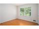 Bedroom with hardwood floors, white walls, trim and a window with natural light at 1703 W Nancy Creek Ne Dr, Brookhaven, GA 30319