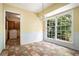 Cozy breakfast nook with a large window, chandelier, and tile floors, adjacent to the laundry room at 1703 W Nancy Creek Ne Dr, Brookhaven, GA 30319