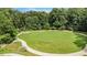 A well manicured common green is surrounded by winding sidewalks and lush, mature trees at 1703 W Nancy Creek Ne Dr, Brookhaven, GA 30319