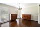 Classic dining room with hardwood floors, vintage furnishings, and natural light from the windows at 1703 W Nancy Creek Ne Dr, Brookhaven, GA 30319