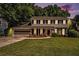 Traditional two-story house with a neatly kept lawn, offering a blend of comfort and curb appeal at 1703 W Nancy Creek Ne Dr, Brookhaven, GA 30319