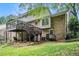 Charming two-story home exterior with a large deck, brick siding, and a well-maintained backyard at 1703 W Nancy Creek Ne Dr, Brookhaven, GA 30319